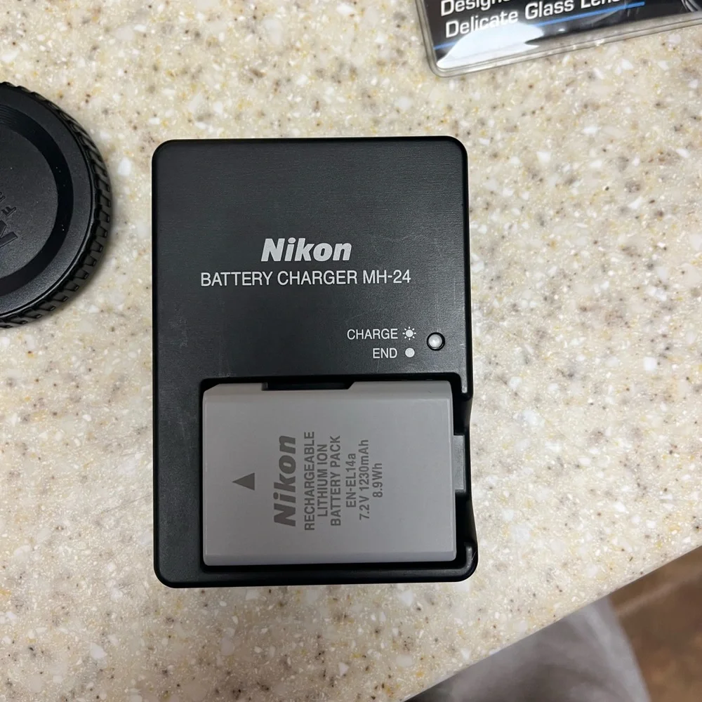 Nikon D3400 DSLR Camera with two lenses, 2 batteries, battery charger, and bag